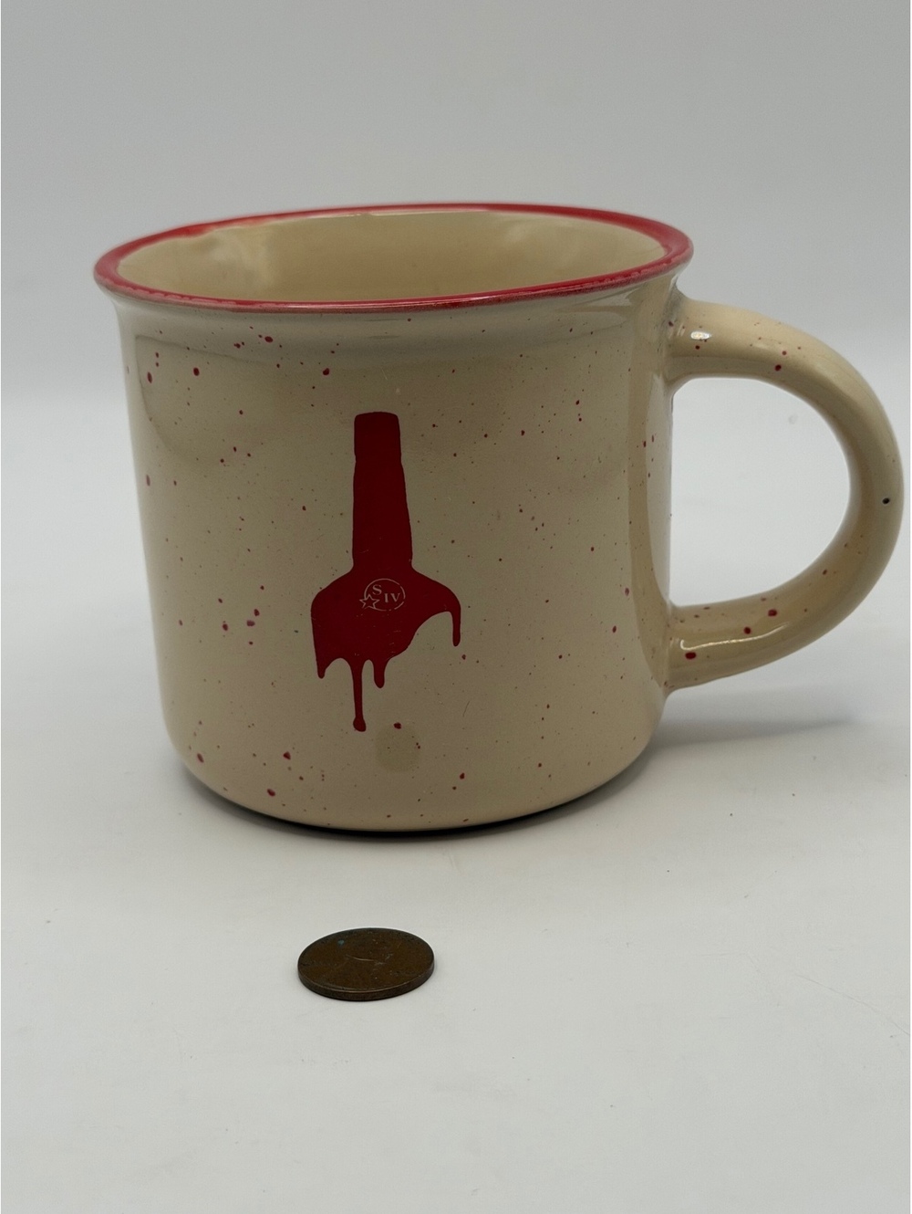 Speckled camp mug with red dripping nail polish